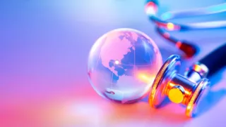 Globe and a stethoscope on a colourful background