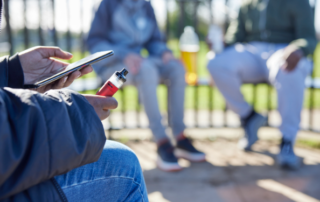 Teens vaping in a park