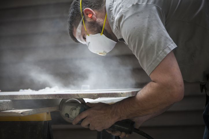 Man working with artificial stone