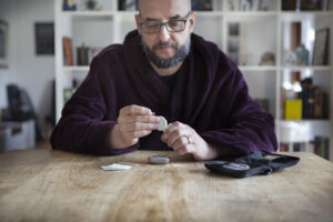 Diabetic man testing his blood sugar levels with glucose machine