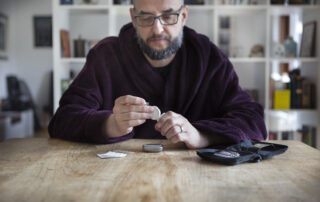 Diabetic man testing his blood sugar levels with glucose machine