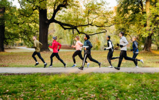 A group of runners racing through the park