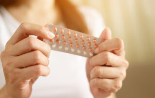 Woman's hands holding a packet of contraceptive pills