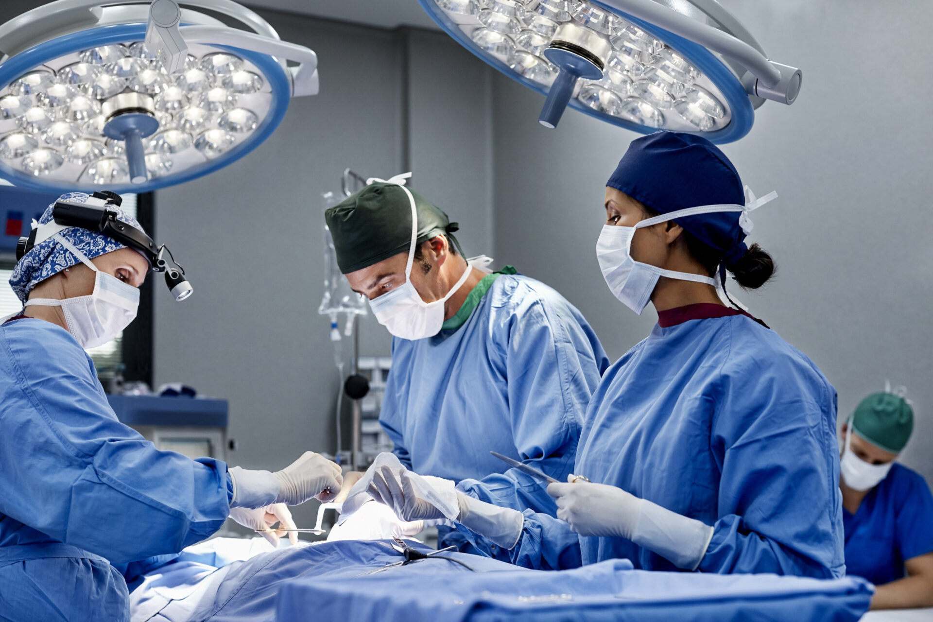 Female surgeon operating patient at emergency room Female surgeon operating patient at emergency room
