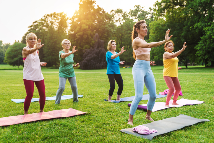 Senior women training with fitness coach at park