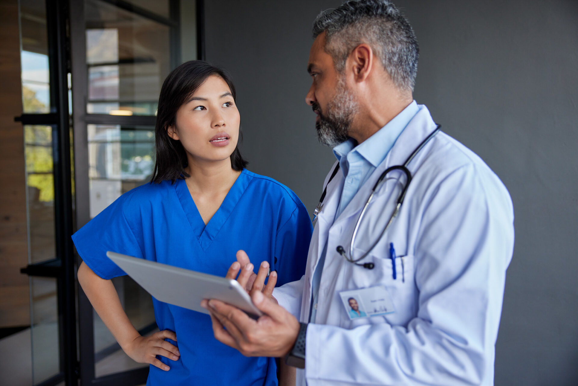 Doctor and asian nurse talking about therapy to perform on patient A doctor and nurse having a discussion