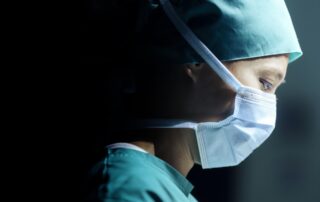 facial expression Close-up of a young adult female surgeon operating and wearing a surgical mask and copy space