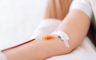 Hand with an infusion system through which blood flows
