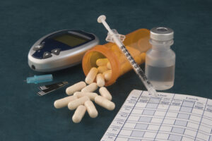 A picture of pills and diabetic supplies