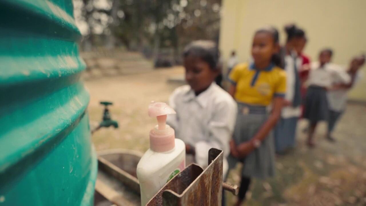 Children lining up to wash hands