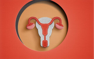 Stylized illustration of the female reproductive system (uterus, ovaries, fallopian tubes) in a circular window on an orange background.