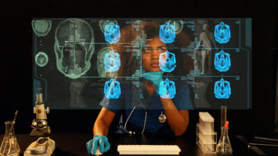 Female clinician in gloves and stethoscope studies blue brain scans on a holographic monitor.