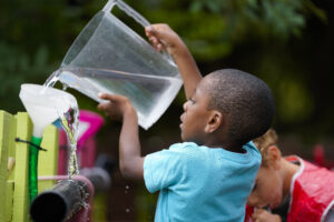 Boy pouring water
